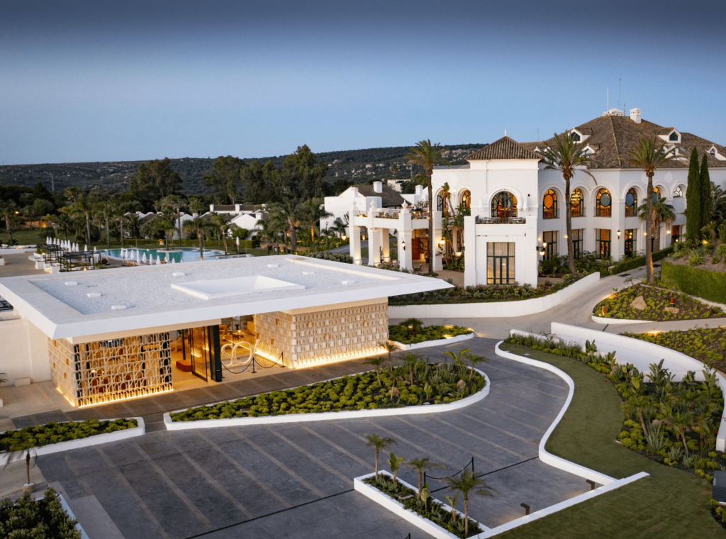 A private luxurious complex basks in the golden hues of a sunset, embodying the opulence and exclusivity of Sotogrande real estate.