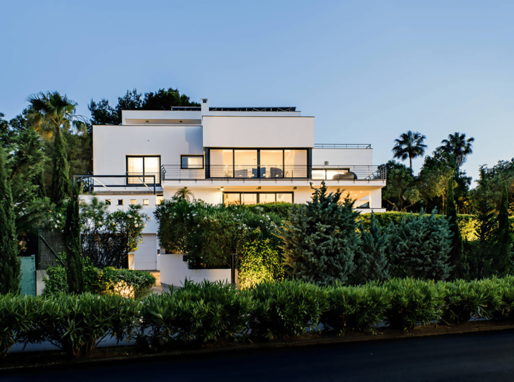 A luxury home bathed in the warm glow of a sunset, epitomizing the elegance and sophistication of Sotogrande real estate.
