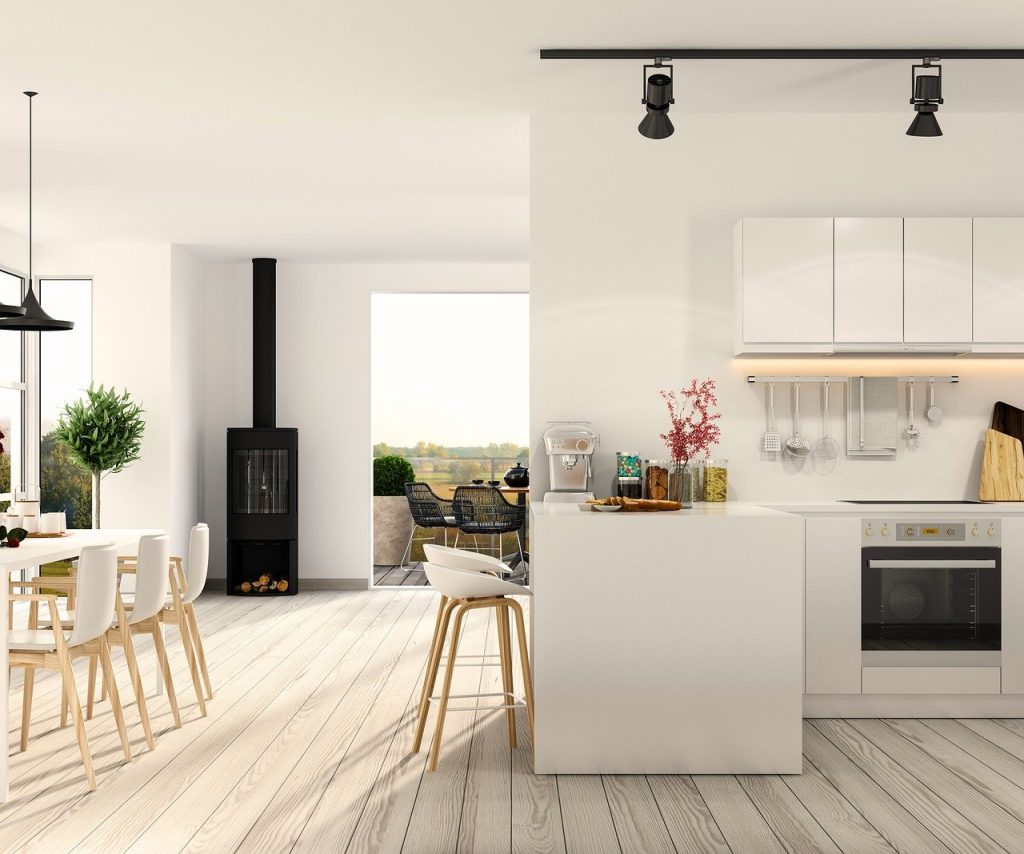 Modern open-plan kitchen and dining area in a luxury Sotogrande home with outdoor terrace views.