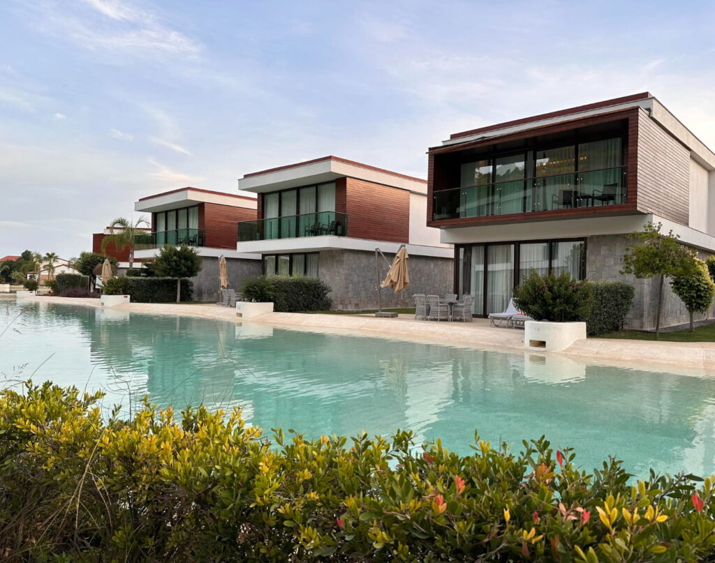 Luxury villas for sale in Sotogrande with shared pool, modern architecture, and wood-clad facades
